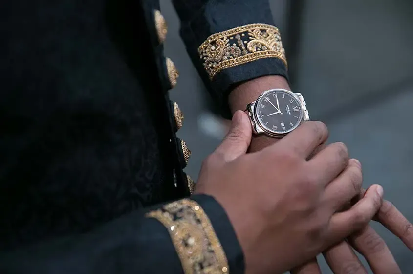 asian wedding groom watch before
